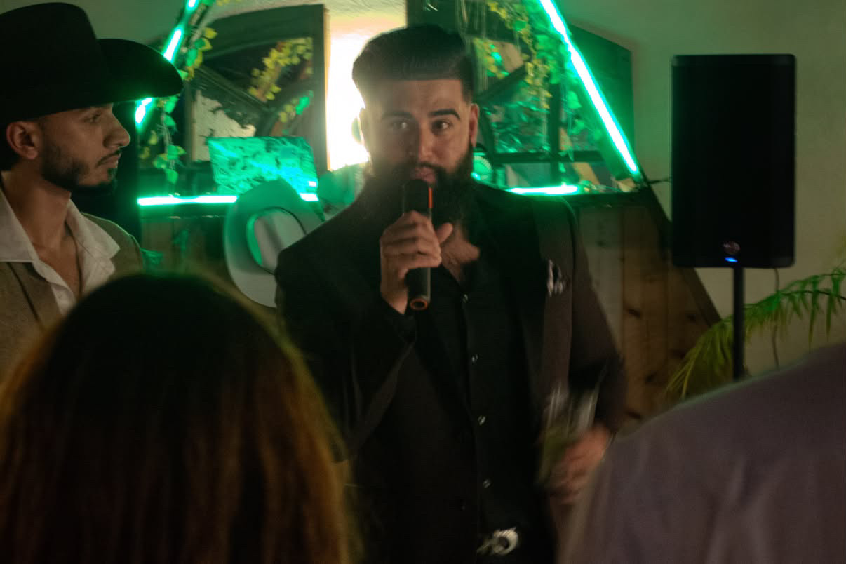 Charles Patawaran speaking to guests with a microphone