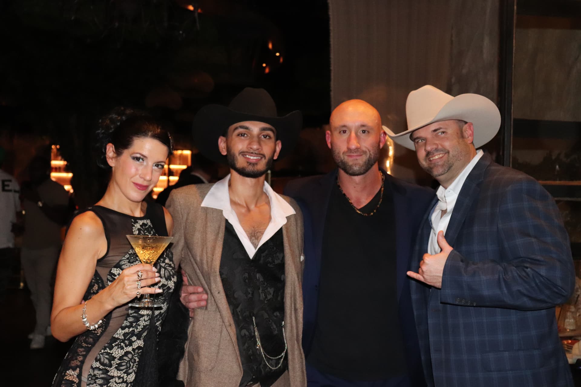 Highline guests in cowboy hats enjoying an evening together