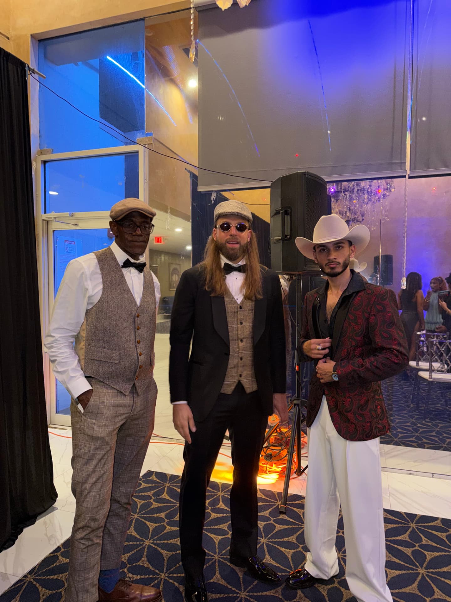Three guests in western suits and cowboy hats
