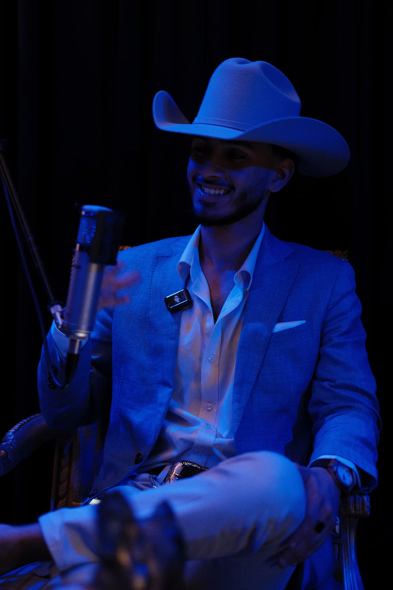Highline podcast host speaking into a professional studio microphone