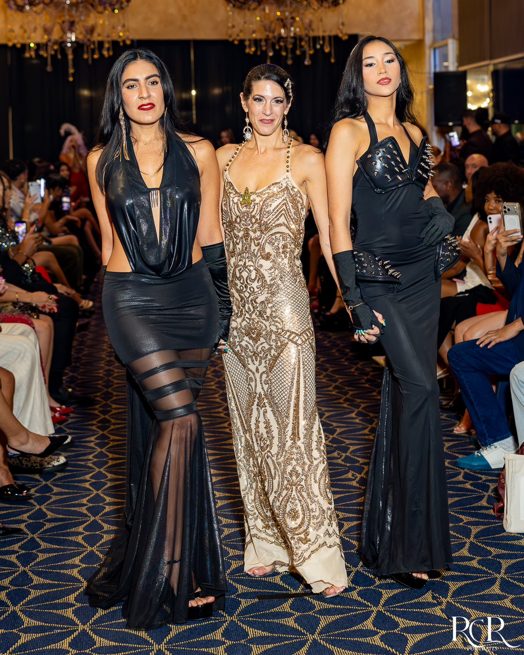 Three models in evening gowns on the runway at The Gatsby Affair