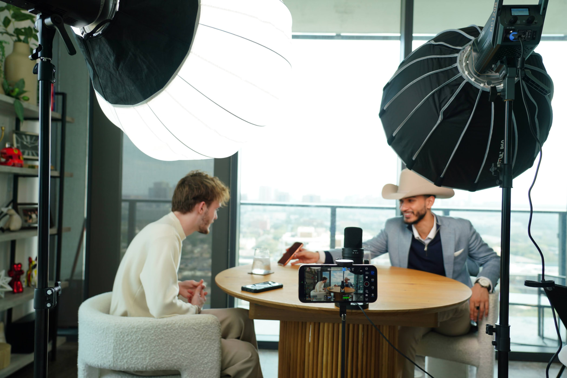 HLE interview at a round table with microphones and large studio lights